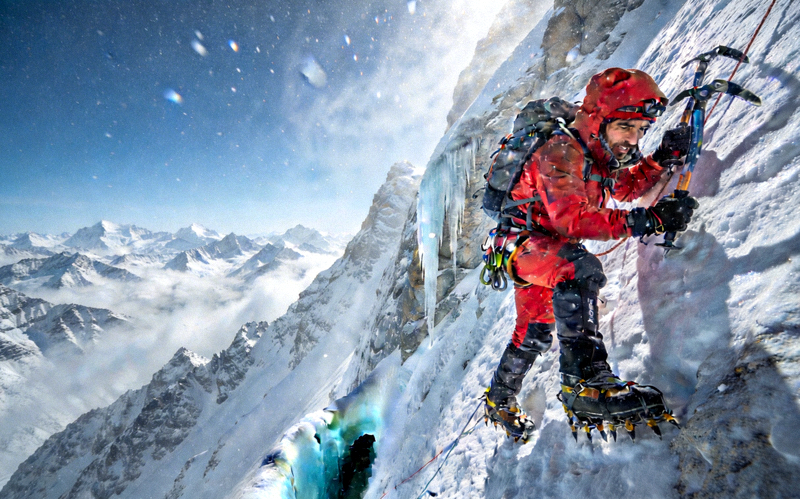 高海拔登山者在陡峭雪山攀爬的惊险场景